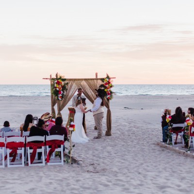 Bamboo set up with burlap, red ribbons on chairs